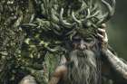 Close-up of man with antler hat and beard Art Print